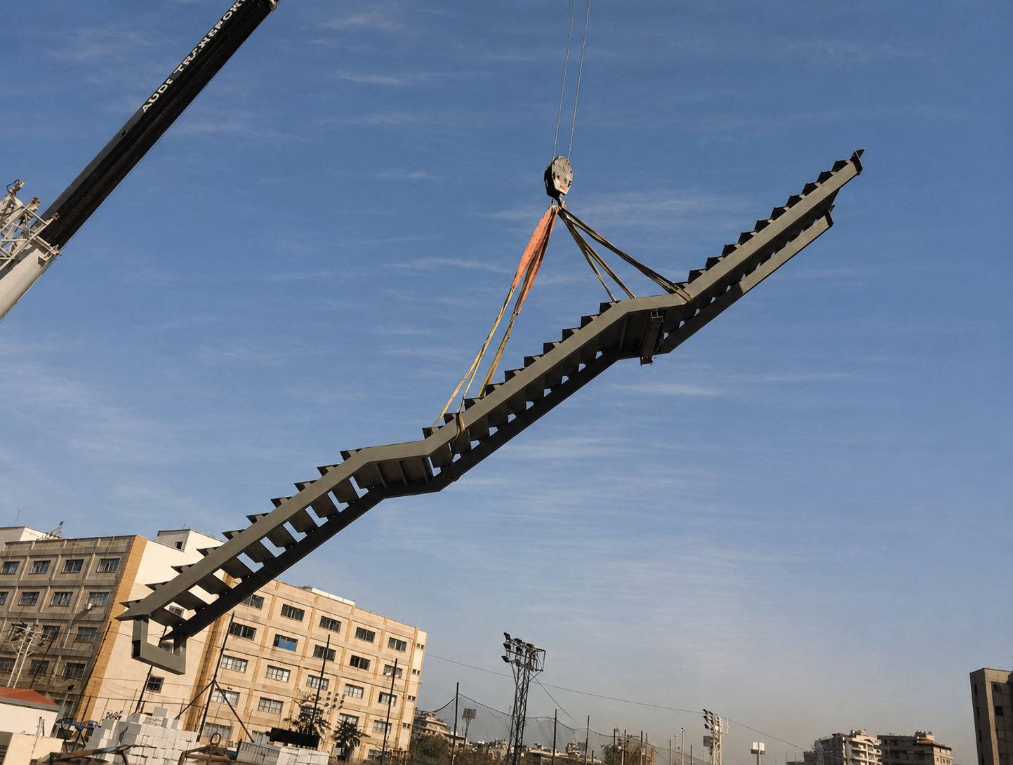 Fabricated steel staircase lifted into place by a crane